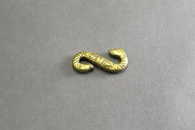 Akan. <em>Gold-weight (abrammuo): double-headed snake</em>, 19th century. Copper alloy, length: 3 in. (length: 4.9 cm). Brooklyn Museum, Gift of Shirley B. Williams, 1990.221.36. Creative Commons-BY (Photo: Brooklyn Museum, 1990.221.36_front_PS5.jpg)