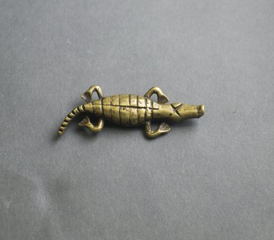 Akan. <em>Gold-weight (abrammuo): crocodile</em>, 19th century. Copper alloy, length: 3 in. (length: 7.2 cm. Brooklyn Museum, Gift of Shirley B. Williams, 1990.221.53. Creative Commons-BY (Photo: Brooklyn Museum, 1990.221.53_front_PS5.jpg)