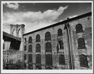 Tony Velez (American, born 1946). <em>Brooklyn Bridge and Empire Stores (Warehouse), Brooklyn, NY.</em>, 1990. Gelatin silver print, Image: 10 x 13 1/2 in. (25.4 x 34.3 cm). Brooklyn Museum, Gift of Paul Velez, 1991.308.14. © artist or artist's estate (Photo: Brooklyn Museum, 1991.308.14_PS1.jpg)