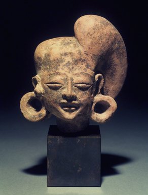  <em>Head of a Figure with Baroque Headdress</em>, 13th-14th century. Terracotta, height (includes stand): 7 5/8 in. Brooklyn Museum, Gift of Cynthia Hazen Polsky, 1991.79.10. Creative Commons-BY (Photo: Brooklyn Museum, 1991.79.10.jpg)