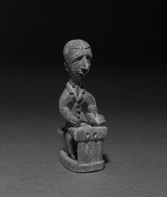 Yorùbá. <em>Figure of a District Officer</em>, 20th century. Wood, 9 1/4 x 6 1/4 in. Brooklyn Museum, Gift of Eugene and Harriet Becker, 1992.134. Creative Commons-BY (Photo: Brooklyn Museum, 1992.134_bw.jpg)