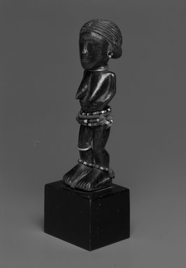 Attie. <em>Standing Female Figure</em>, early 20th century. Wood, metal, string, glass, 7 x 1 1/4 in.  (17.8 x 3.2 cm). Brooklyn Museum, Gift of Drs. Noble and Jean Endicott, 1992.136.5. Creative Commons-BY (Photo: Brooklyn Museum, 1992.136.5_view1_bw.jpg)