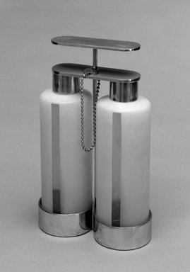 Russel Wright (American, 1904-1976). <em>Tantalus Decanter Set: Holder, Two Decanters, Two Caps, Lock, Key</em>, ca. 1930. Chromed brass, colorless and frosted glass, white metal, 11 11/16 x 7 3/8 x 3 5/8 in.  (29.7 x 18.7 x 9.2 cm). Brooklyn Museum, Marie Bernice Bitzer Fund, 1992.247a-g. Creative Commons-BY (Photo: Brooklyn Museum, 1992.247a-g_bw.jpg)