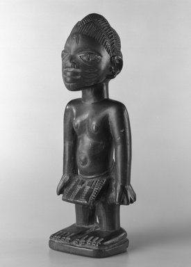 Yorùbá artist. <em>Male twin figure (Ère Ìbejì)</em>, early 20th century. Wood, metal, nails, 7 3/4 x 2 1/4 in. (19.7 x 5.7 cm). Brooklyn Museum, Gift of the David and Margery Edwards Collection, 1992.67.1. Creative Commons-BY (Photo: Brooklyn Museum, 1992.67.1_bw.jpg)
