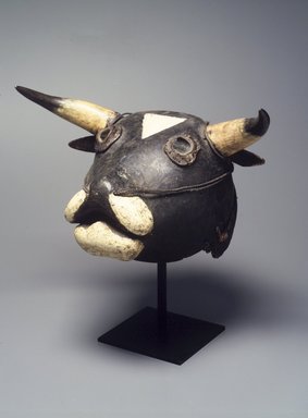 Bijagó. <em>Ox Mask (Dugn'be)</em>, 20th century. Wood, raffia, bone, glass, metal, fur, paint, fiber, 15 1/2 x 19 x 9in. (39.4 x 48.3 x 22.9cm). Brooklyn Museum, Gift of Mr. and Mrs. Joseph Gerofsky, 1992.69.3. Creative Commons-BY (Photo: Brooklyn Museum, 1992.69.3_transp499.jpg)