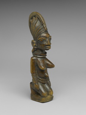 Yorùbá. <em>Kneeling Female Figure</em>, late 19th or early 20th century. Wood, 8 1/2 x 2 x 2 1/2 in. (21.6 x 5.1 x 6.4 cm). Brooklyn Museum, Gift of Mr. and Mrs. Joseph Gerofsky in honor of Ruth Lippman, 1992.70. Creative Commons-BY (Photo: Brooklyn Museum, 1992.70_threequarter_PS2.jpg)