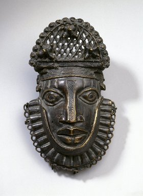 Edo. <em>Hip Ornament with Human Face (Uhunmwu-Ẹkuẹ)</em>, 18th century (possibly). Copper alloy, iron, 6 13/16 × 4 5/16 × 2 1/4 in. (17.3 × 11 × 5.7 cm). Brooklyn Museum, Gift of Beatrice Riese, 1994.143. Creative Commons-BY (Photo: Brooklyn Museum, 1994.143_SL1.jpg)