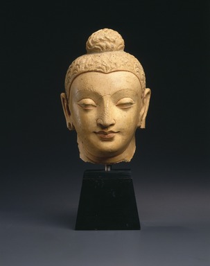  <em>Head of a Buddha</em>, 3rd-5th century. Stucco with polychrome decoration, height: approximately 8 in. Brooklyn Museum, Purchased with funds given by Dr. Bertram H. Schaffner, 1995.135. Creative Commons-BY (Photo: Brooklyn Museum, 1995.135_SL1.jpg)