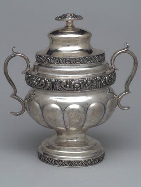 Unknown. <em>Sugar Bowl with Lid,  Part of Three-Piece Set</em>, ca. 1826–1828. Silver, 9 3/4 x 8 1/2 x 5 3/4 in. (14.7 x 21.6 x 13.3 cm). Brooklyn Museum, Gift of Marcelle H. Littell, 1995.151.3a-b. Creative Commons-BY (Photo: Brooklyn Museum, 1995.151.3a-b.jpg)