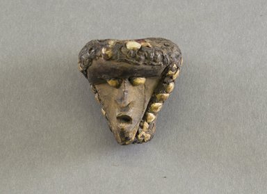 Bassa. <em>Personal Miniature Mask</em>, 20th century. Wood, organic matter, shell?, 2 1/8 x 2 1/4 in. (5.4 x 5.7 cm). Brooklyn Museum, Gift of Blake Robinson, 1995.7.13. Creative Commons-BY (Photo: Brooklyn Museum, 1995.7.13_front_PS5.jpg)