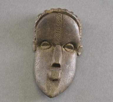 Bassa. <em>Personal Miniature Mask</em>, 20th century. Wood, 5 x 2 3/4 x 1 1/2 in. (12.7 x 7 x 3.8 cm). Brooklyn Museum, Gift of Blake Robinson, 1995.7.69. Creative Commons-BY (Photo: Brooklyn Museum, 1995.7.69_front_PS5.jpg)