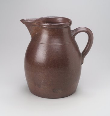 Charles Graham Chemical Pottery Works (1878–ca. 1913). <em>Pitcher</em>, late 19th century. Stoneware, 10 1/4 x 9 1/2 x 8 in. (26.0 x 24.1 x 20.4 cm). Brooklyn Museum, Gift of M. Christmann Zulli, 1996.10.1. Creative Commons-BY (Photo: Brooklyn Museum, 1996.10.1.jpg)