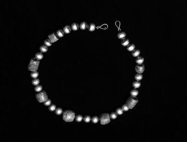  <em>Necklace</em>, 1934. Serpentine beads (prehispanic), silver beads (modern), length: 16 1/4 in. Brooklyn Museum, Bequest of Mrs. Carl L. Selden, 1996.116.11. Creative Commons-BY (Photo: Brooklyn Museum, 1996.116.11_bw.jpg)