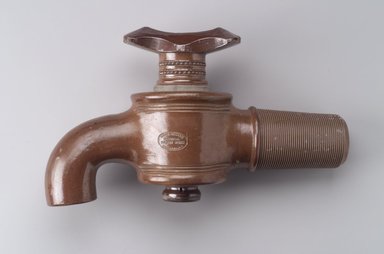 Charles Graham Chemical Pottery Works (1878-ca. 1913). <em>Bib Faucet</em>, late 19th century. Glazed stoneware, 9 1/2 x 16 1/2 x 5 1/2 in. (24.0 x 42.0 x 14.0 cm). Brooklyn Museum, Gift of Emma and Jay Lewis, 1996.8. Creative Commons-BY (Photo: Brooklyn Museum, 1996.8.jpg)