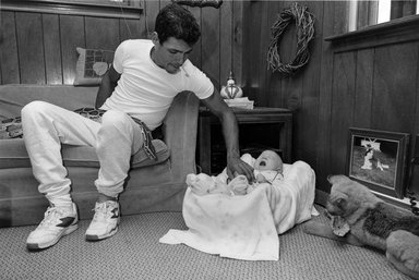 Sage Sohier (American, born 1954). <em>[Untitled] (Man Baby-sitting with Snake)</em>, 1992. Gelatin silver print, image: 12 1/4 x 18 1/4 in. (31.2 x 46.4 cm). Brooklyn Museum, Purchased with funds given by Karen B. Cohen and Alfred T. White Fund, 1997.51. © artist or artist's estate (Photo: Brooklyn Museum, 1997.51_bw.jpg)
