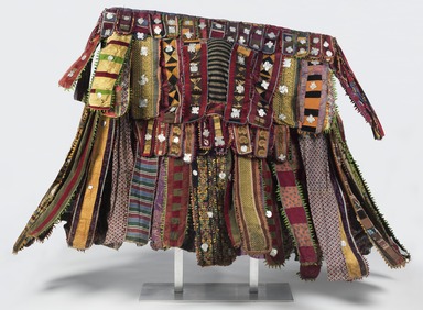 Yorùbá. <em>Egúngún Masquerade Dance Costume (paka egúngún)</em>, ca. 1920-1948. Cotton, wool, wood, silk, synthetic textiles (including viscose rayon and acetate), indigo, and aluminum, est.: 55 x 6 x 63 in. (139.7 x 15.2 x 160 cm). Brooklyn Museum, Gift of Sam Hilu, 1998.125. Creative Commons-BY (Photo: , 1998.125_front_PS11.jpg)