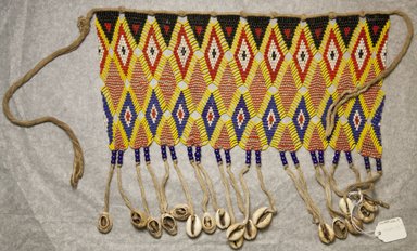 Kirdi. <em>Beaded Apron</em>, early 20th century. Colored glass beads, cotton, shells, 6 3/8 x 13 3/4 in.  (16.2 x 34.9 cm);. Brooklyn Museum, Gift of Mark S. Rapoport, M.D. and Jane C. Hughes, 1999.133.7. Creative Commons-BY (Photo: Brooklyn Museum, 1999.133.7_front_PS10.jpg)