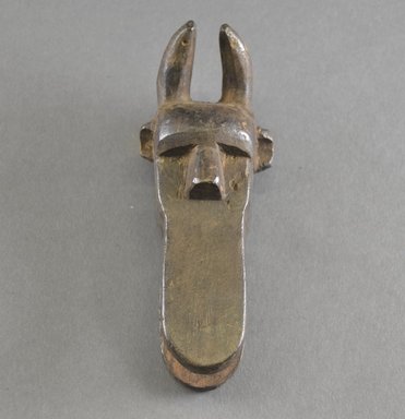 Loma. <em>Personal Miniature Mask</em>, early 20th century. Wood, 6 1/8 x 2 3/8 x 1 7/8 in. (15.6 x 6 x 4.8 cm). Brooklyn Museum, Gift of Blake Robinson, 2000.70.1. Creative Commons-BY (Photo: Brooklyn Museum, 2000.70.1_front_PS5.jpg)