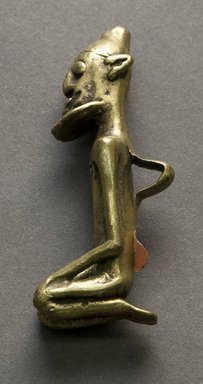 Dogon. <em>Kneeling Male Figure</em>, 19th century or earlier. Copper alloy, 2 1/2 x 5/8 x 1 1/8 in. (6.4 x 1.6 x 2.9 cm). Brooklyn Museum, Bequest of Samuel Eilenberg
, 2001.29.1. Creative Commons-BY (Photo: Brooklyn Museum, 2001.29.1_side_PS10.jpg)