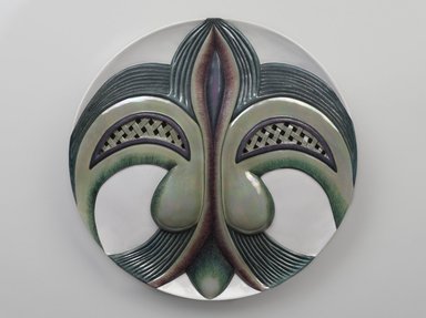Judy Chicago (American, born 1939). <em>Eleanor of Aquitaine Place Setting</em>, 1974-1979. Runner: Cotton/linen base fabric, woven interface support material (horsehair, wool, and linen), cotton twill tape, silk, synthetic gold cord, tapestry, bleached linen, wool, silk satin, silk thread, felt, appliquéd fabric, thread
Plate: Porcelain with overglaze enamel (China paint) and rainbow luster glaze, Runner: 52 3/8 x 30 5/8 in. (133 x 77.8 cm). Brooklyn Museum, Gift of The Elizabeth A. Sackler Foundation, 2002.10-PS-19. © artist or artist's estate (Photo: Brooklyn Museum, 2002.10-PS-19_plate_PS9.jpg)