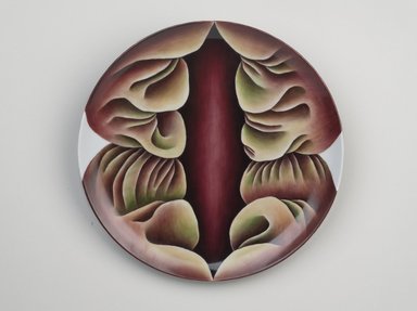 Judy Chicago (American, born 1939). <em>Primordial Goddess Place Setting</em>, 1974–1979. Runner:Cotton/linen base fabric, woven interface support material (horsehair, wool, and linen), cotton twill tape, silk, synthetic gold cord, unborn calf skins, cowry shells, stone beads, fabric paint, thread
Plate: Porcelain with overglaze enamel (China paint), Runner: 53 1/2 x 30 1/2 in. (135.9 x 77.5 cm). Brooklyn Museum, Gift of The Elizabeth A. Sackler Foundation, 2002.10-PS-1. © artist or artist's estate (Photo: Brooklyn Museum, 2002.10-PS-1_plate_PS9.jpg)