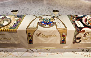 Judy Chicago (American, born 1939). <em>Hildegarde of Bingen Place Setting</em>, 1974-1979. Runner:Cotton/linen base fabric, woven interface support material (horsehair, wool, and linen), cotton twill tape, silk, synthetic gold cord, cotton cord, felt, silk thread, silk satin fabric, colored cords, unknown padding materials, thread
Plate: Porcelain with overglaze enamel (China paint) and metallic iridescent luster glaze, Runner: 51 3/4 x 30 1/2 in. (131.4 x 77.5 cm). Brooklyn Museum, Gift of The Elizabeth A. Sackler Foundation, 2002.10-PS-20. © artist or artist's estate (Photo: , 2002.10-PS-20_Hildegarde_of_Bingen_Jook_Leung_photo_9332r2.jpg)