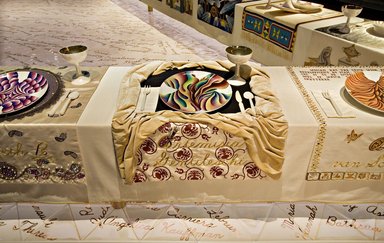 Judy Chicago (American, born 1939). <em>Artemisia Gentileschi Place Setting</em>, 1974-1979. Runner: Decorative fabrics, cotton/linen base fabric, woven interface support material (horsehair, wool, and linen), cotton twill tape, silk, synthetic gold cord, silk velvet fabric, felt, linen interface, silk fabrics, textile paint, metallic cord, silk thread
Plate: Porcelain with overglaze enamel (China paint), Runner: 53 x 32 1/2 in. (134.6 x 82.6 cm). Brooklyn Museum, Gift of The Elizabeth A. Sackler Foundation, 2002.10-PS-25. © artist or artist's estate (Photo: , 2002.10-PS-25_Artemesia_Gentileschi_Jook_Leung_photo_9342r2.jpg)