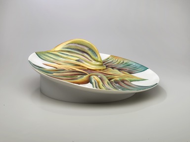 Judy Chicago (American, born 1939). <em>Mary Wollstonecraft Place Setting</em>, 1974-1979. Runner: Silk satin, cotton/linen base fabric, woven interface support material (horsehair, wool, and linen), cotton twill tape, silk, synthetic gold cord, felt padding, braid, buttons, lace, kid leather, ribbons, feathers, suede leather, silk, paint, silk thread
Plate: Porcelain with overglaze enamel (China paint), Runner: 52 1/2 x 30 3/4 in. (133.4 x 78.1 cm). Brooklyn Museum, Gift of The Elizabeth A. Sackler Foundation, 2002.10-PS-30. © artist or artist's estate (Photo: , 2002.10-PS-30_plate_PS1.jpg)