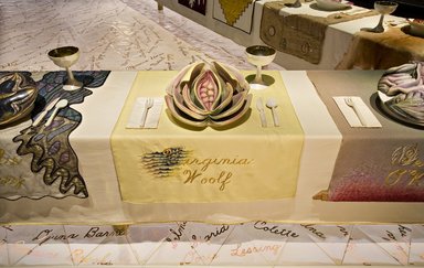 Judy Chicago (American, born 1939). <em>Virginia Woolf Place Setting</em>, 1974-1979. Runner: Cotton/linen base fabric, woven interface support material (horsehair, wool, and linen), cotton twill tape, silk, synthetic gold cord, airbrushed acrylic paint, silk chiffon, silk embroidery thread,
Plate: Porcelain with overglaze enamel (China paint), Runner: 52 x 30 1/8 in. (132.1 x 76.5 cm). Brooklyn Museum, Gift of The Elizabeth A. Sackler Foundation, 2002.10-PS-38. © artist or artist's estate (Photo: , 2002.10-PS-38_Virginia_Woolf_Jook_Leung_photo_9377r2.jpg)
