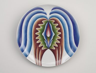 Judy Chicago (American, born 1939). <em>Hatshepsut Place Setting</em>, 1974-1979. Runner: Cotton/linen base fabric, woven interface support material (horsehair, wool, and linen), cotton twill tape, silk, synthetic gold cord, polychrome DMC thread, canvas, silk thread
Plate:Porcelain with overglaze enamel (China paint), Runner:52 x 30 1/4 in. (132.1 x 76.8 cm). Brooklyn Museum, Gift of The Elizabeth A. Sackler Foundation, 2002.10-PS-8. © artist or artist's estate (Photo: Brooklyn Museum, 2002.10-PS-8_plate_PS9.jpg)