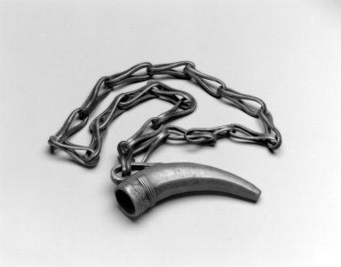Dan or. <em>Pendant on Chain</em>, 19th century. Copper alloy, Pendant: 4 3/4 x 1 1/4 x 2 5/8 in. (12.1 x 3.2 x 6.7 cm). Brooklyn Museum, Gift of Blake Robinson in memory of Phillip Ravenhill, 2002.31.21. Creative Commons-BY (Photo: Brooklyn Museum, 2002.31.21_bw.jpg)