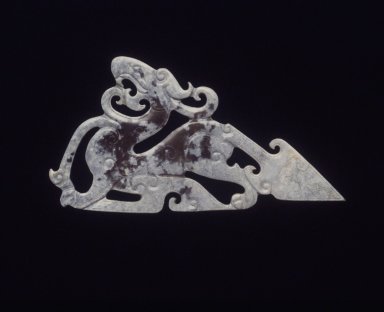  <em>Dragon Pendant with Triangular Tail</em>, 20th century. Yellow-green nephrite, 4 x 2 1/8 x 1/8 in. (10.2 x 5.4 x 0.3 cm). Brooklyn Museum, Gift of Mr. and Mrs. Raymond Hargreaves, 2002.36.3. Creative Commons-BY (Photo: Brooklyn Museum, 2002.36.3_transp5686.jpg)