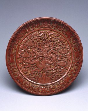  <em>Dish Depicting a Dragon Amongst Foliage</em>, 1522-1566. Carved cinnabar lacquer on wood, diameter: 7 3/8 in. (18.7 cm). Brooklyn Museum, Gift of Patricia Falk, from the Collection of Pauline B. and Myron S. Falk, Jr., 2003.30. Creative Commons-BY (Photo: Brooklyn Museum, 2003.30_SL1.jpg)