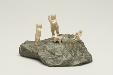 Inuit. <em>Scene: Two Men, a Child, and a Dog</em>, 1950-1980. Stone, ivory, 3 1/4 x 5 1/2 x 4 3/4 in. (8.3 x 14 x 12.1 cm). Brooklyn Museum, Hilda and Al Schein Collection, 2004.79.25. Creative Commons-BY (Photo: Brooklyn Museum, 2004.79.25_view01_PS11-1.jpg)