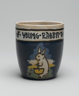 AM. <em>Mug, "It is the Habit of Young Rabbit to go to School,"</em> 1917. Glazed earthenware, Height: 3 5/8 in. (9.2 cm). Brooklyn Museum, Gift of Joseph F. McCrindle in memory of J. Fuller Feder, by exchange, 2007.7.3. Creative Commons-BY (Photo: Brooklyn Museum, 2007.7.3_view1_PS2.jpg)