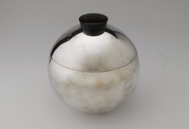 Louis W. Rice (American, 1872-1933). <em>Ice Bucket and Lid, "Bomb Rumidor Pattern,"</em> ca. 1930. Silver-plated metal, rosewood, lacquer, glass, 8 1/2 x 8 1/4 in. (21.6 x 21 cm). Brooklyn Museum, Gift of John C. Waddell, 2008.89.2a-b. Creative Commons-BY (Photo: Brooklyn Museum, 2008.89.2a-b_PS4.jpg)