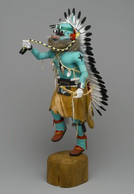 Orin Poley. <em>Kachina Doll (Sakwahote)</em>, 1960–1970. Cottonwood root, acrylic pigment, hide, feathers, shell, fur,  turquioise, metal, 17 3/4 x 6 x 9 in. (45.1 x 15.2 x 22.9 cm). Brooklyn Museum, Gift of Edith and Hershel Samuels, 2010.6.1. Creative Commons-BY (Photo: Brooklyn Museum, 2010.6.1_threequarter_left_PS2.jpg)