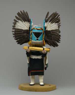 Seona. <em>Kachina Doll (Angwusnasomtaqa [Crow Mother])</em>, 1960-1970. Cottonwood root, acrylic paint, feathers, fur, hide, synthetic wool and yarn, painted canvas, 15 x 9 x 4 1/2 in. (38.1 x 22.9 x 11.4 cm). Brooklyn Museum, Gift of Edith and Hershel Samuels, 2010.6.2. Creative Commons-BY (Photo: Brooklyn Museum, 2010.6.2_front_PS2.jpg)