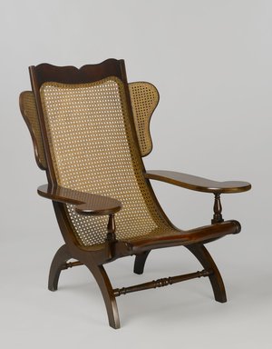 Unknown. <em>Easy Chair (Butaca)</em>, second quarter 19th century. Mahogany, cane, 43 x 35 3/4 x 35 3/8 in. (109.2 x 90.8 x 89.9 cm). Brooklyn Museum, Gift of Mrs. J. Fuller Feder, by exchange and Brooklyn Museum Collection, 2011.58.1. Creative Commons-BY (Photo: Brooklyn Museum, 2011.58.1_PS6.jpg)