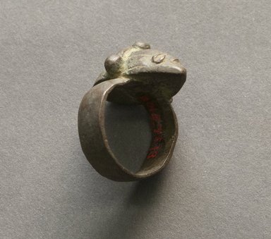 Senufo. <em>Ring with Human Face</em>, early 20th century. Bronze, 1 1/4 x 7/8 x 7/8 in. (3.1 x 2.2 x 2.3 cm). Brooklyn Museum, Gift of Jerome Vogel, 2012.76.13. Creative Commons-BY (Photo: Brooklyn Museum, 2012.76.13_PS10.jpg)
