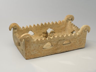  <em>Tray with Bird Heads</em>, 1st millennium B.C.E. Clay, 4 7/16 x 11 5/16 x 6 1/8 in. (11.3 x 28.8 x 15.6 cm). Brooklyn Museum, Gift of the Arthur M. Sackler Foundation, NYC, in memory of James F. Romano, 2015.65.24. Creative Commons-BY (Photo: Brooklyn Museum, 2015.65.24_PS9.jpg)