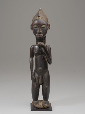 Baule artist. <em>Figure of a Male</em>. Wood, pigment, organic materials, upholstery stud, with mount: 16 7/8 x 5 in. (42.8 x 12.7 cm). Brooklyn Museum, Gift of the Ralph and Fanny Ellison Charitable Trust, 2015.88.6. Creative Commons-BY (Photo: Brooklyn Museum, 2015.88.6_front_PS9.jpg)