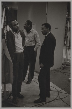 Milt Hinton (born Vicksburg Mississippi, active Chicago, IL, 1910–2000). <em>J.J. Johnson, Osie Johnson and Miles Davis, recording studio, N.Y.C.</em>, ca. 1957. Gelatin silver print, 11 × 14 in. (27.9 × 35.6 cm). Brooklyn Museum, Gift of David Berger and Holly Maxson, 2023.80.9 (Photo: Brooklyn Museum, 2023.80.9_PS20.jpg)