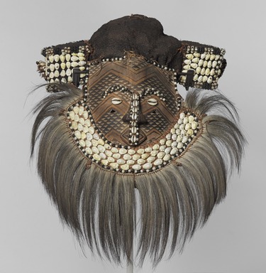 Kuba (Bushoong subgroup) artist. <em>Mask (Mwaash aMbooy)</em>, late 19th or early 20th century. Rawhide, paint, plant fibers, textile, cowrie shells, glass, wood, monkey pelt, feathers, 22 x 20 x 18 in. (55.9 x 50.8 x 45.7 cm). Brooklyn Museum, Museum Expedition 1922, Robert B. Woodward Memorial Fund, 22.1582. Creative Commons-BY (Photo: , 22.1582_overall_PS9.jpg)