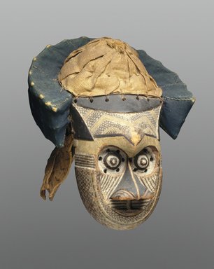 Kuba (Bushoong subgroup). <em>Mask (Pwoom Itok)</em>, late 19th century. Wood, shell, cloth, raffia, pigment, 15 3/8 x 11 1/4 x 11 3/4 in. (39.1 x 28.6 x 29.8 cm). Brooklyn Museum, Museum Expedition 1922, Robert B. Woodward Memorial Fund, 22.230. Creative Commons-BY (Photo: Brooklyn Museum, 22.230_SL1.jpg)