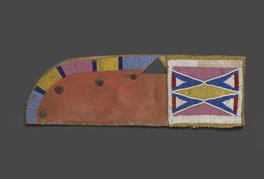 Oglala, Lakota, Sioux. <em>Knife Sheath, Part of War Outfit</em>, late 19th–early 20th century. Rawhide, pigment, beads, nails, 13 1/2 x 4 1/2 in. (34.3 x 11.4 cm). Brooklyn Museum, Robert B. Woodward Memorial Fund, 26.788. Creative Commons-BY (Photo: Brooklyn Museum, 26.788_PS1.jpg)