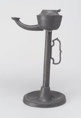 American. <em>Lamp</em>, 19th century. Pewter, 9 1/2 x 5 1/4 x 4 5/8 in. (24.1 x 13.3 x 11.7 cm). Brooklyn Museum, Gift of Mrs. Samuel Doughty
, 27.526. Creative Commons-BY (Photo: Brooklyn Museum, 27.462.jpg)