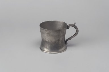 Attributed to William Calder (American, 1817-1856). <em>Cup with Handle</em>, 1817-1856. Pewter, 2 7/8 x 3 7/8 x 2 7/8 in. (7.3 x 9.8 x 7.3 cm). Brooklyn Museum, Gift of Mrs. Samuel Doughty, 27.463. Creative Commons-BY (Photo: Brooklyn Museum, 27.463.jpg)