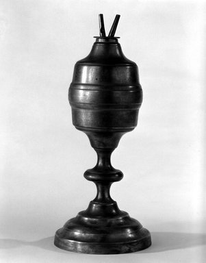 Capen and Molineux. <em>Lamp</em>, 1848-1854. Pewter, copper, 11 1/4 x 4 13/16 in. (28.5 x 12.3 cm). Brooklyn Museum, Gift of Mrs. Samuel Doughty, 27.520b. Creative Commons-BY (Photo: Brooklyn Museum, 27.520b_bw.jpg)