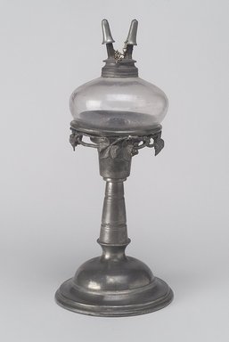 Unknown. <em>Lamp</em>, ca. 1850. Pewter, glass, metal, 10 x 4 3/8 x 4 3/8 in. (25.4 x 11.1 x 11.1 cm). Brooklyn Museum, Gift of Mrs. Samuel Doughty, 27.638. Creative Commons-BY (Photo: Brooklyn Museum, 27.638.jpg)